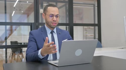Shocked Man Reacts to News on Laptop Computer