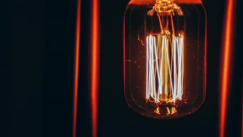 Vintage bulb light flickering, glowing, black background, loop footage, looping background, retro la