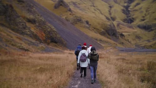 Group of Hikers Walking on Mountain Trail in Iceland Valley