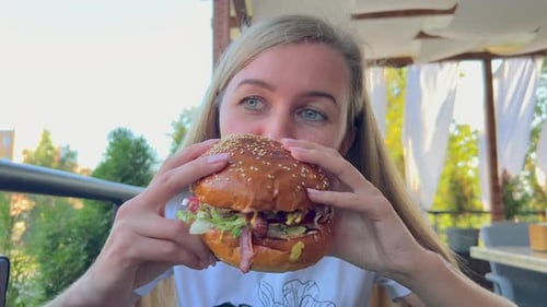 A Hungry Woman Eats a Big Burger Street Food Junk Food Hot Dog Burger Hamburger