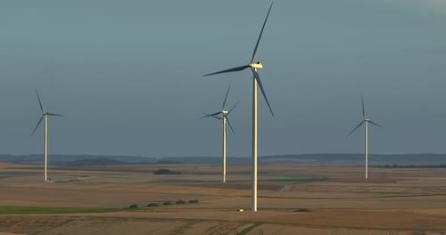 Silhouette of a Windmill in the Sun Aerial Close Up Shot of Wind Mills Rotating By the Force of the