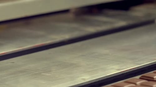 chocolate bars are moved by a suction machine