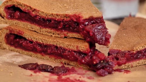 Delicious cherry pie filling bursting out of crust