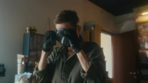 Person Wearing Respirator Mask in Workshop Setting