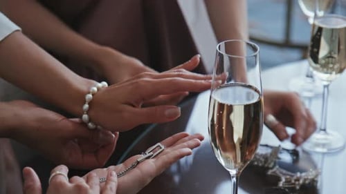 Women Displaying Jewelry and Drinking Champagne