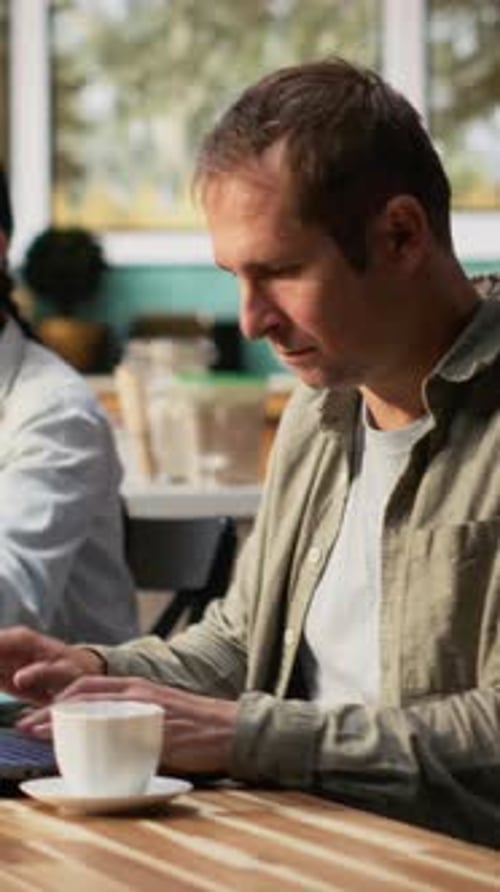 Vertical Video Busy Working Dad Typing on Laptop at Kitchen Table with His Family