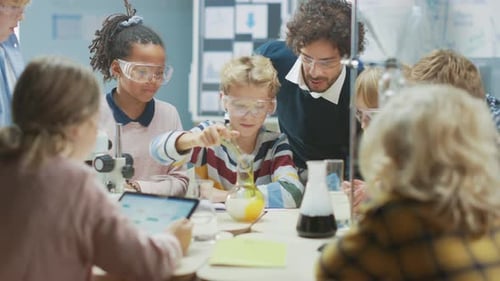 Elementary School Science Classroom: Enthusiastic Teacher Explains Chemistry to Diverse Group of Ch
