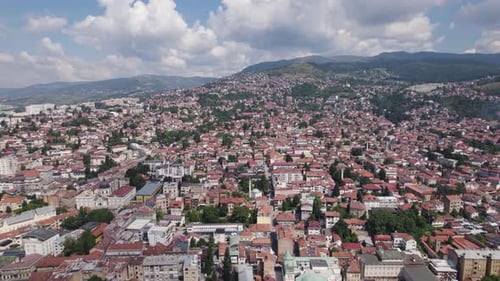 Breathtaking view of Sarajevo's dense red rooftops amid green hills, Bosnia