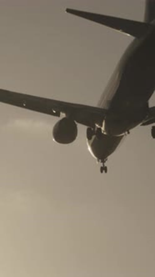Airplane Flying Overhead to Land at Airport in Slow Motion