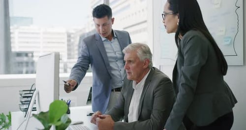 4k video footage of a group of businesspeople working together on a computer in an office