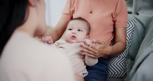 Smiling Infant with Caregiver in Home Setting