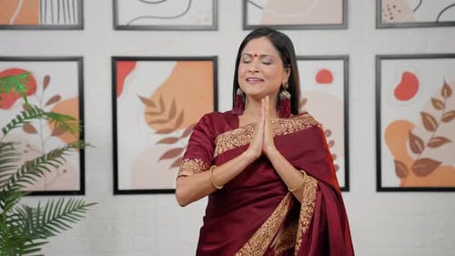 Adult Woman Smiling With Hands Clasped Indoors