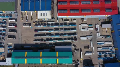 Aerial view of a semi trucks with cargo trailers standing on warehouses ramps for loading unloading