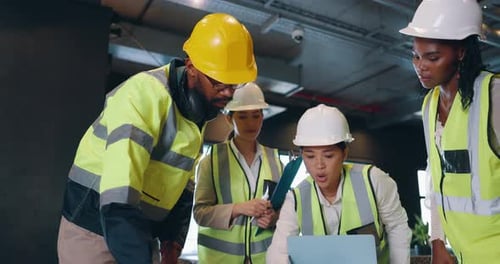 Construction Team Collaborating on Site with Laptop