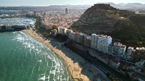 Aerial drone view of the Santa Barbara Castle on the coast of Alicante, Spain with the city and the