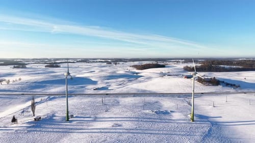 Aerial View of Snowy Wind Turbines in Winter Landscape