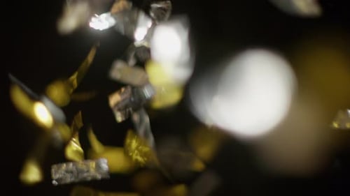 Gold and Silver Confetti Falling in Slow Motion