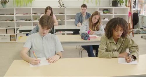 Focused Students Writing Essay Test Exam in School Class. Gen Z High School - College Alumni Scholar