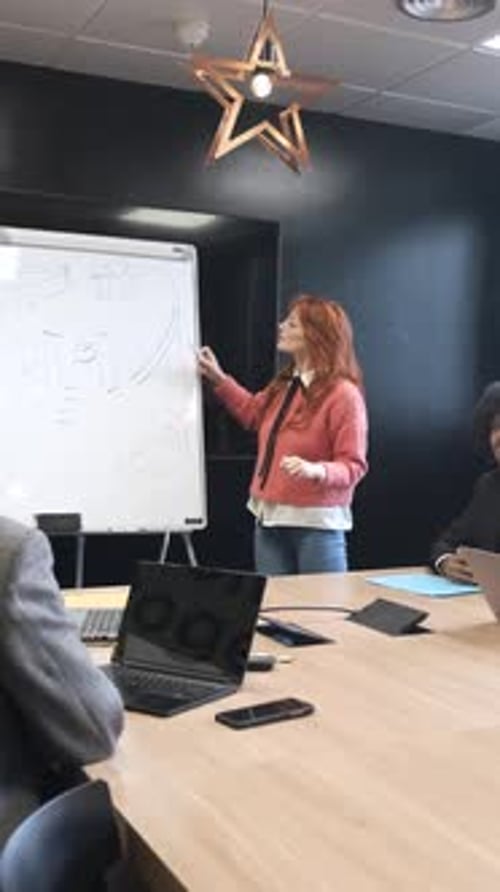 Group of Colleagues Listening to Female Speaker