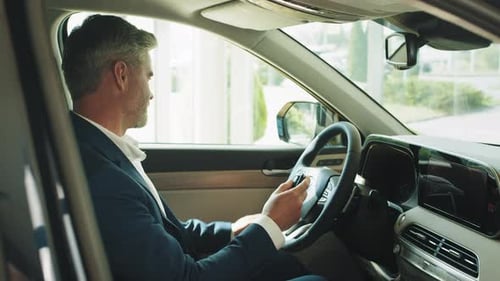 Man in Suit Controls Settings in Car