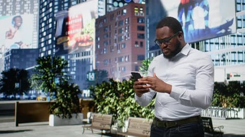 Black Man Disappointed By Bad News on Phone Walking Along City Street