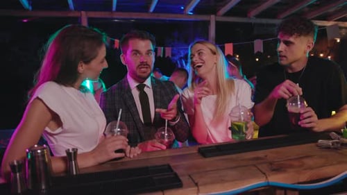 A Group of Friends are Enjoying Colorful Cocktails at a Lively Bar Filled with Cheerful Energy