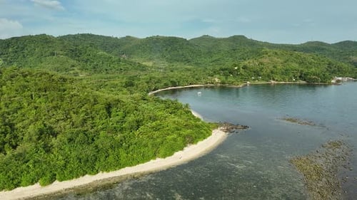 Tropical Island Cove: Lush Green Hills, Sandy Beach, and Tranquil Waters
