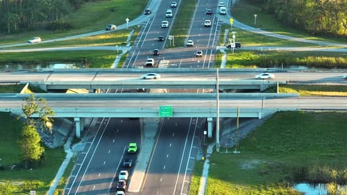 Aerial View of Freeway Overpass Junction with Fast Moving Traffic Cars and Trucks
