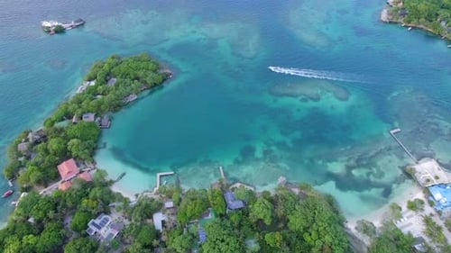 Motorboat sailing in the shores of a tropical exotic Caribbean island. Aerial