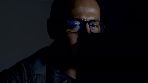 Stock Market Trading Reflection in Glasses of Asian Businessman