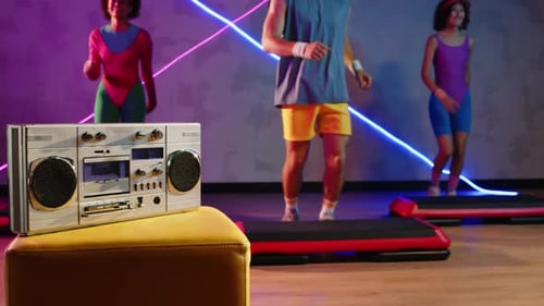 Group Doing Step Aerobics to a Boom Box