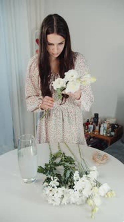 Young Adult Arranging White Flowers in Vase