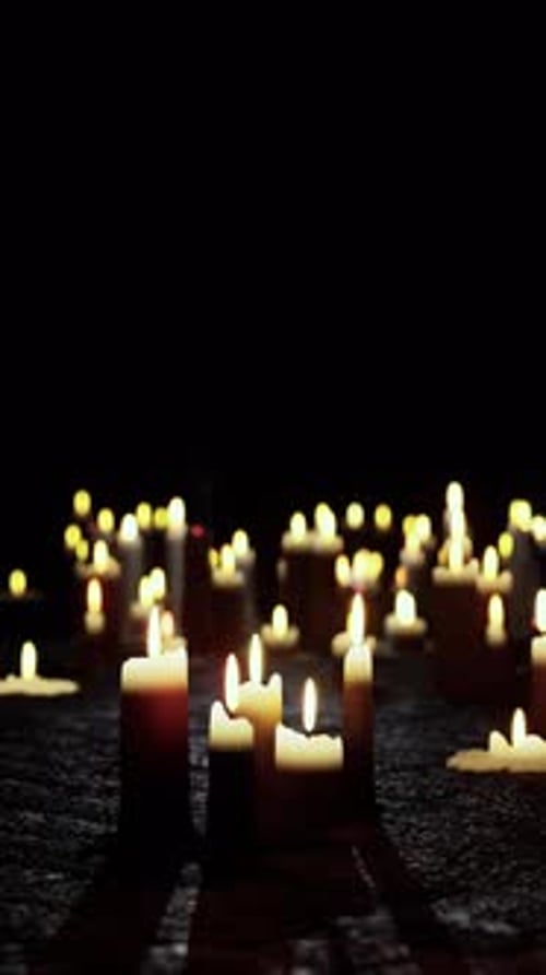 Flickering Candles in Darkness: Commemorative Light Background