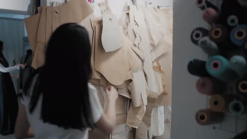 Woman Designs Patterns in Fashion Studio