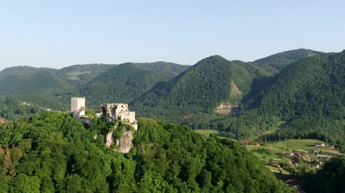 A medieval castle and its ruins on top of a hill