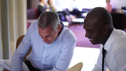 Business Colleagues Discussing Documents in Modern Office