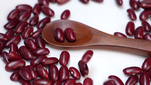 Red Kidney Beans Dropping near Wooden Spoon