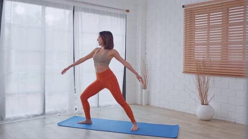 Woman Doing Yoga Exercise on Mat Indoors
