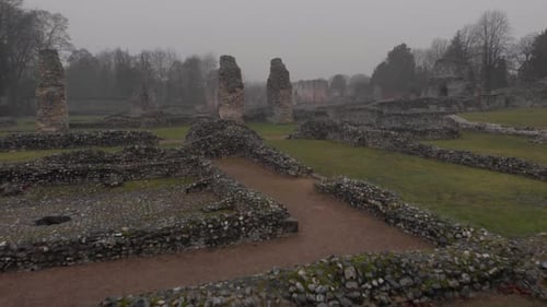 Fast forward moving aerial drone clip over ruins in suburban area in Thethford, England
