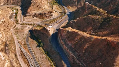 Wavy highways among the canyons are ridden by cars and trucks. Price Canyon, Utah, USA on sunny day.