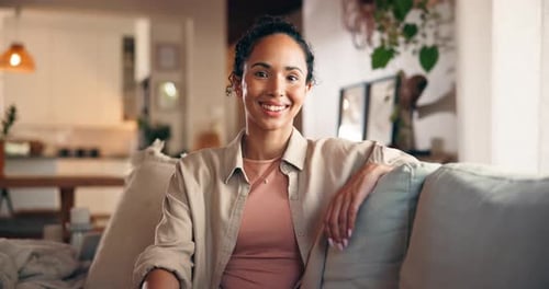 Smiling Woman Relaxing on Couch in Bright Home