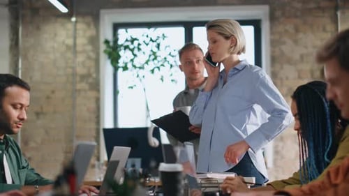 Team Working Together at Long Table in Modern Office