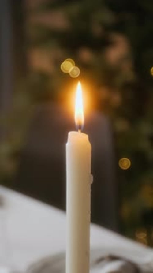 Close Up Of Lit Candle on Table