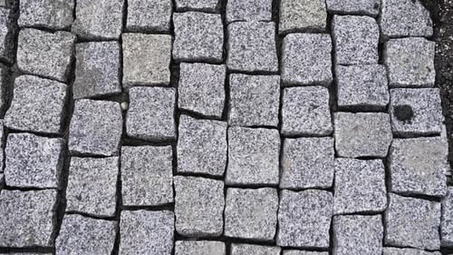 Crosswalk Tiled with Large White Stones on Paved Road