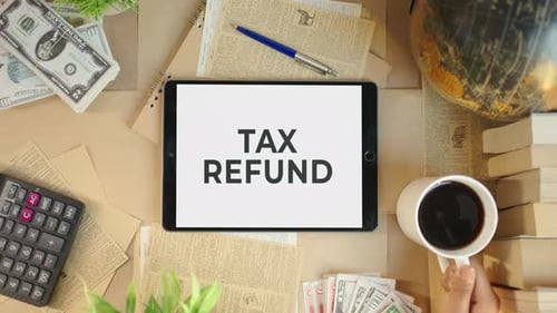 Overhead View of Desktop with 'Tax Refund' Tablet