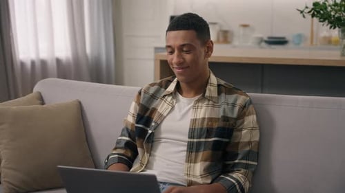 Young Man Working on Laptop From Home