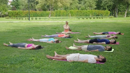 Yogi Woman Playing Singing Bowls During Yoga Meditation in City Park