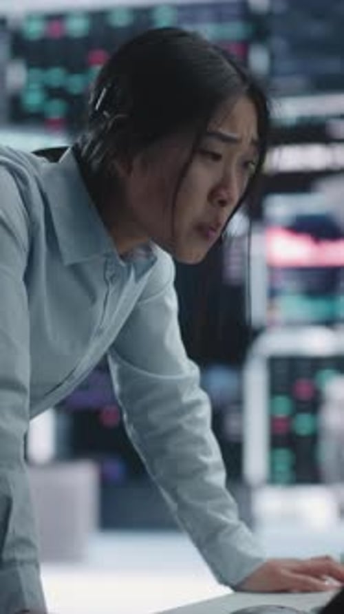 Anxious Female Stock Analyst Confronting Major Loss and Market Volatility at Workstation