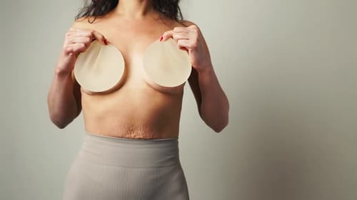 Personal Triumph Woman Displays Removed Breast Implants