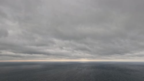 Timelapse Rainy Nimbostratus Clouds Moving in Bright Sunset Sky Over Stormy Sea Abstract Aerial